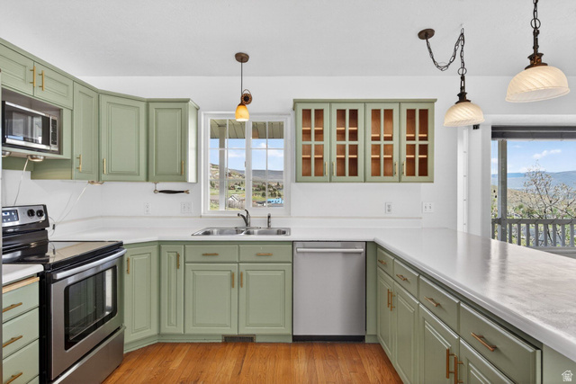 380 Luzern Road Midway, UT 84049 - Photo 11 of 74 Kitchen featuring light green cabinetry with gold hardware, white countertops, and wood-finish flooring