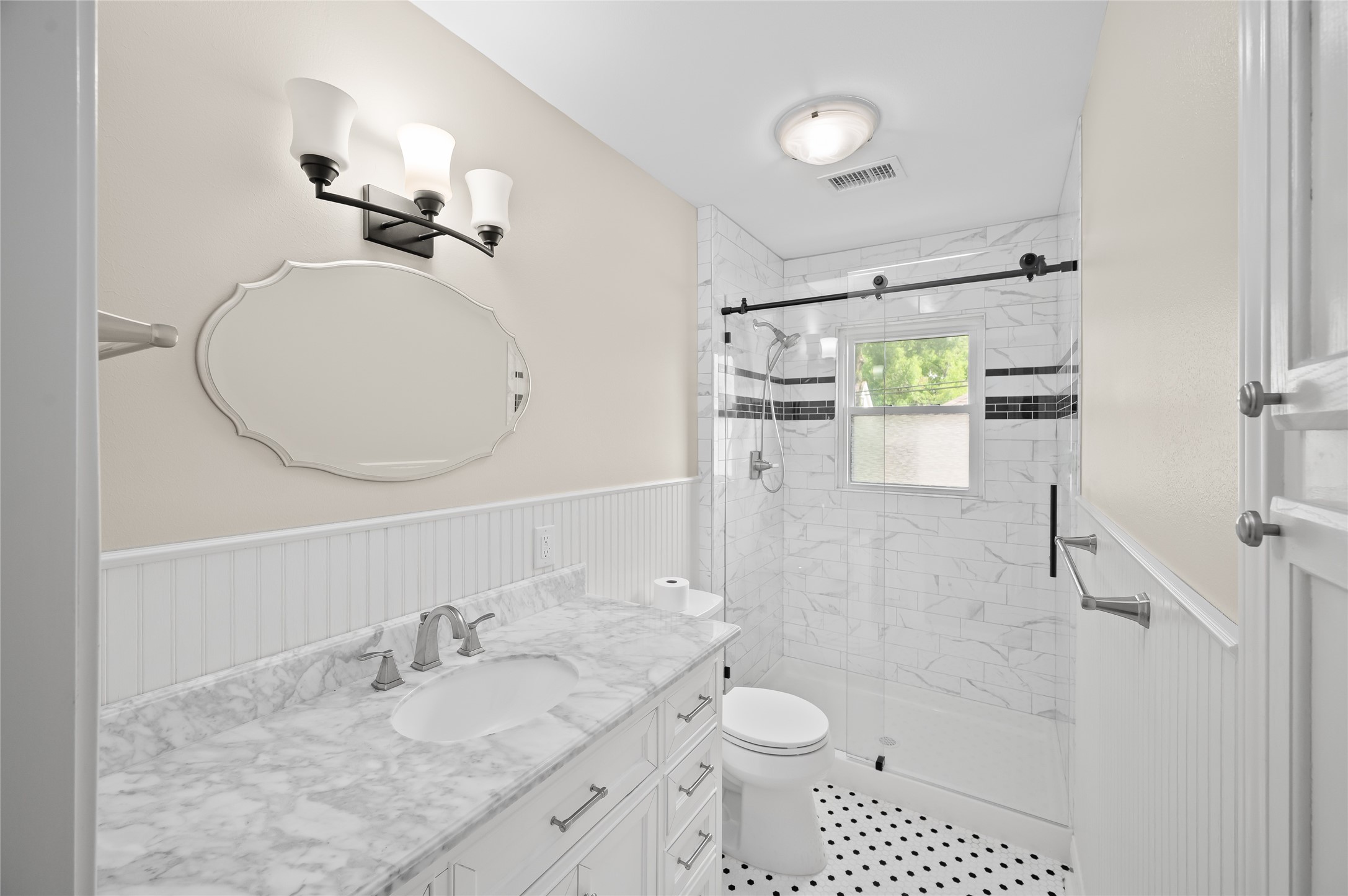 6673 Sylvan Road Houston, TX 77023 - Photo 22 of 39 a bathroom with a granite countertop sink toilet and shower