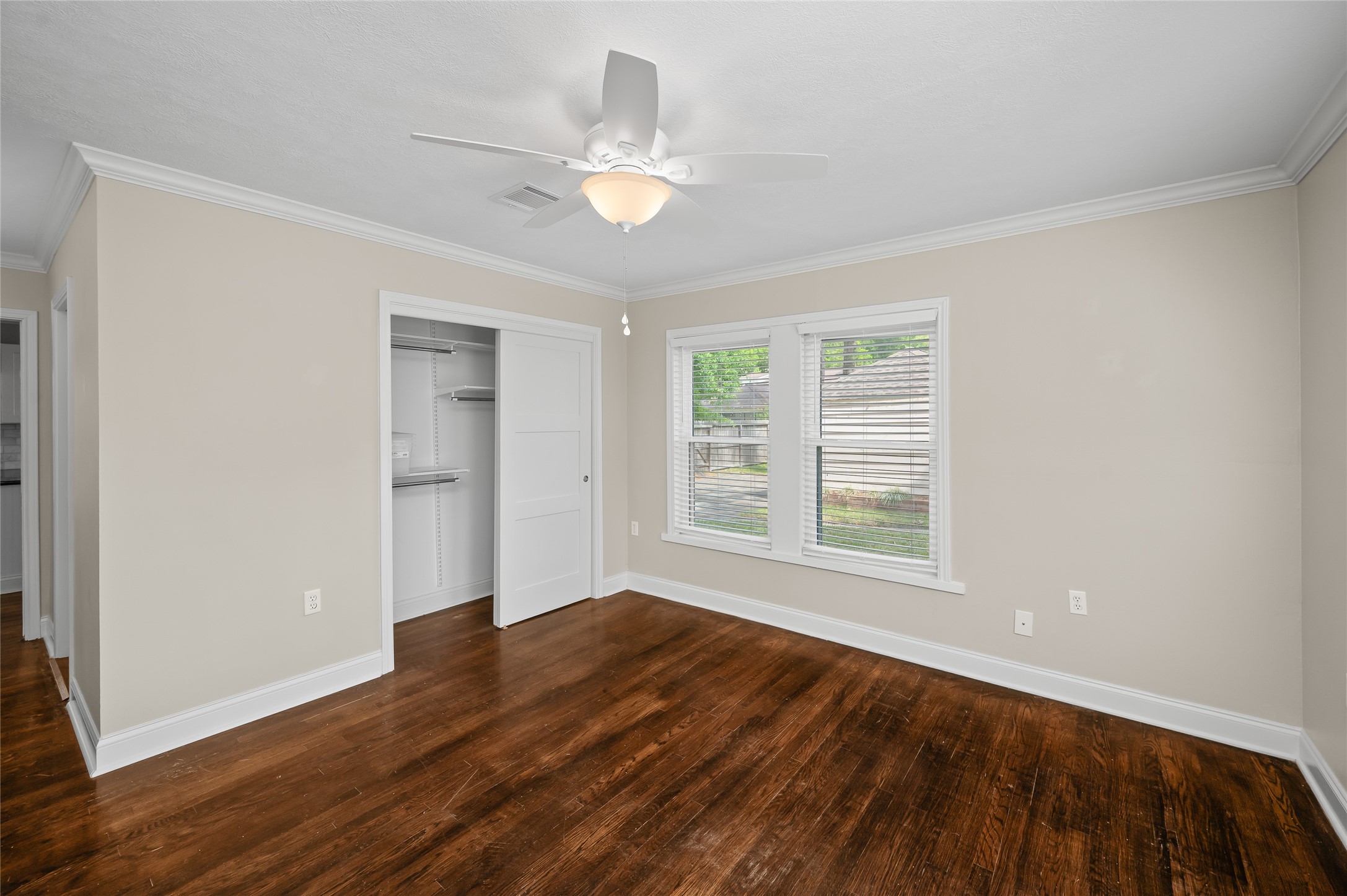 6673 Sylvan Road Houston, TX 77023 - Photo 26 of 39 a view of an empty room with wooden floor and a window