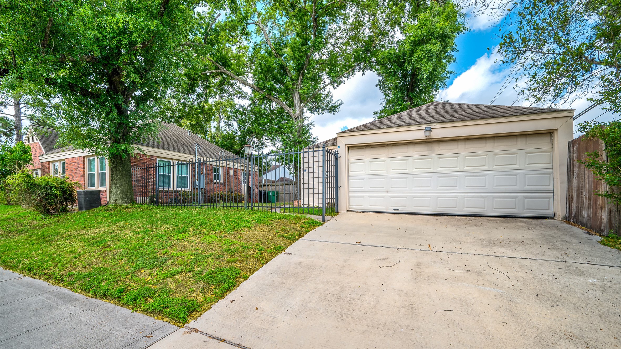 6673 Sylvan Road Houston, TX 77023 - Photo 36 of 39 a front view of a house with a garden and trees