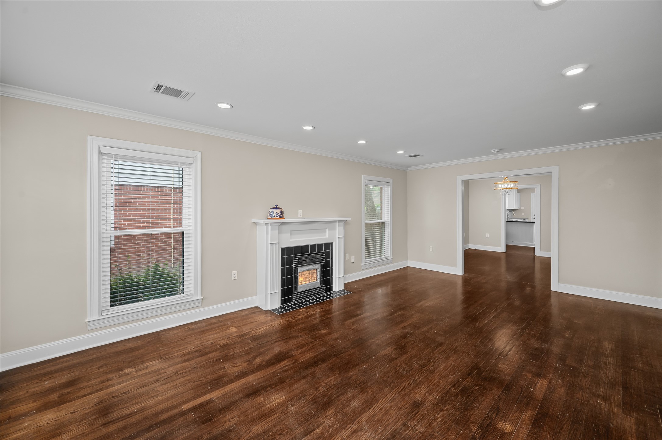 6673 Sylvan Road Houston, TX 77023 - Photo 5 of 39 a view of empty room with wooden floor and fireplace