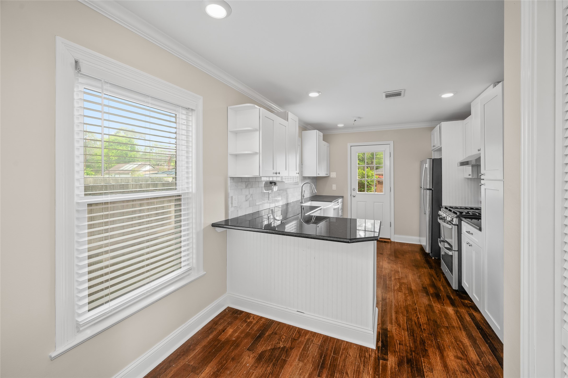 6673 Sylvan Road Houston, TX 77023 - Photo 9 of 39 a kitchen with stainless steel appliances granite countertop a sink a stove a refrigerator and cabinets