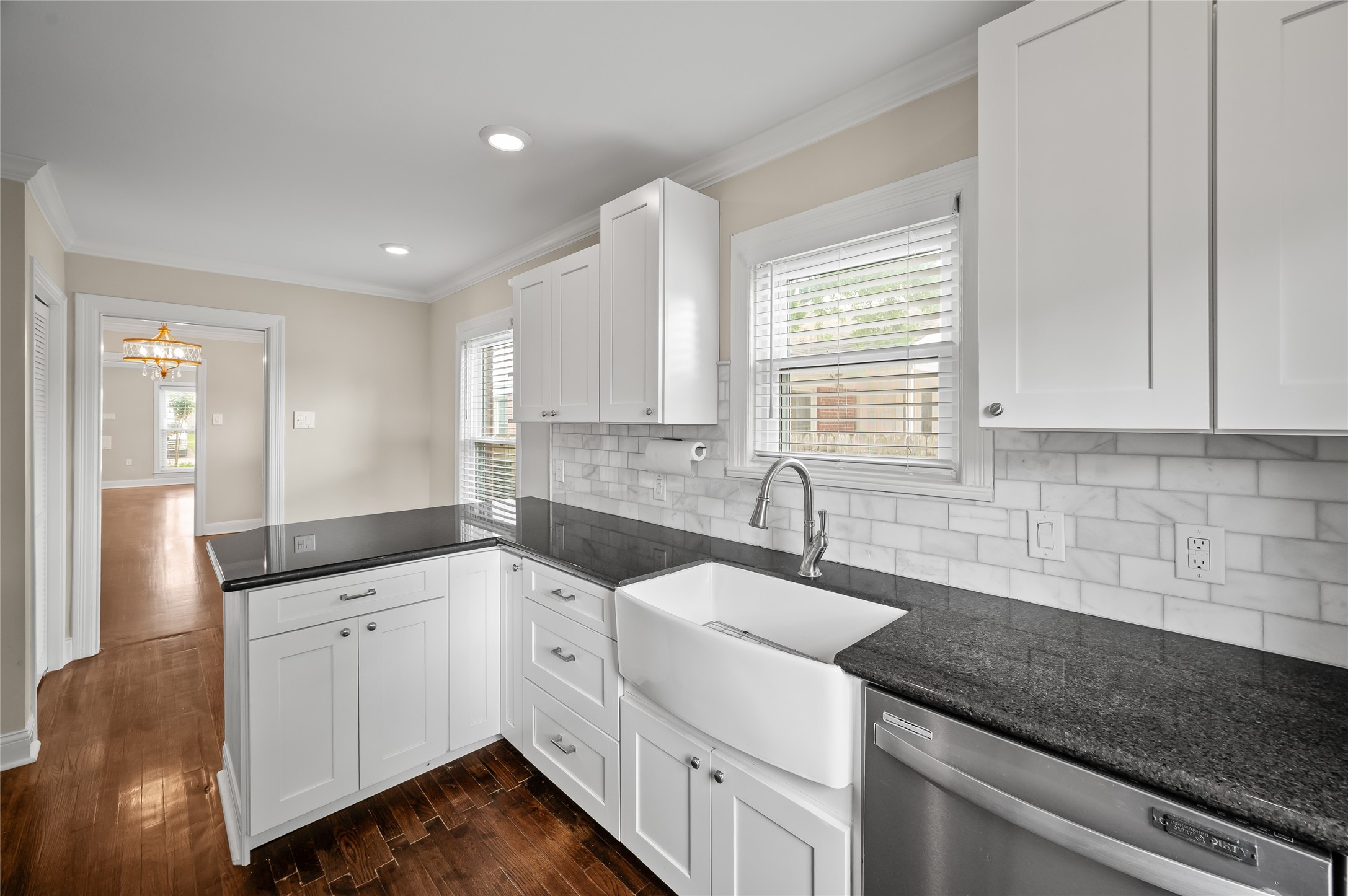 6673 Sylvan Road Houston, TX 77023 - Photo 10 of 39 a kitchen with granite countertop white cabinets and white appliances