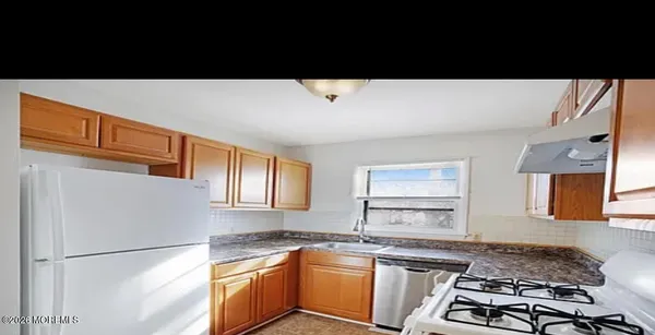 a kitchen with a sink a stove and refrigerator