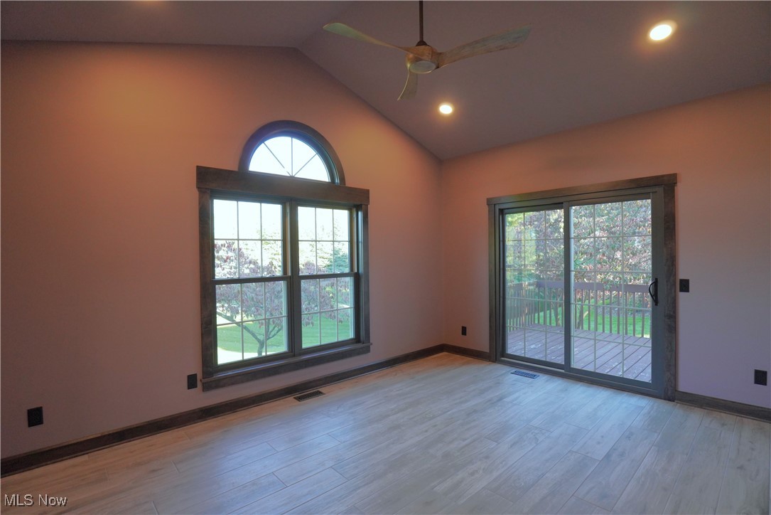 2502 Charing Cross Road Northwest Canton, OH 44708 - Photo 10 of 12 Bonus room featuring ceiling fan, lofted ceiling, and beautiful new windows and door to deck and park-like backyard.