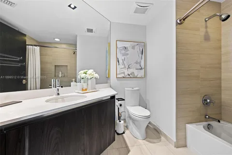 a view of an empty room with wooden floor and a floor to ceiling window