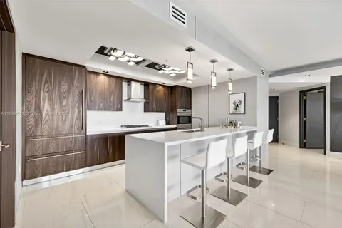 a bedroom with a large bed and a night stand