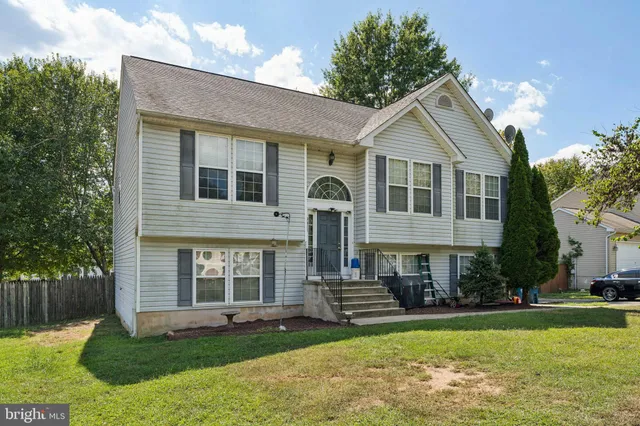 a front view of a house with a yard and porch