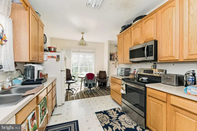 a kitchen with stainless steel appliances a stove sink microwave and cabinets