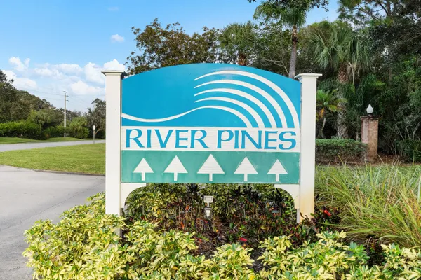 a sign that is sitting in front of flowers