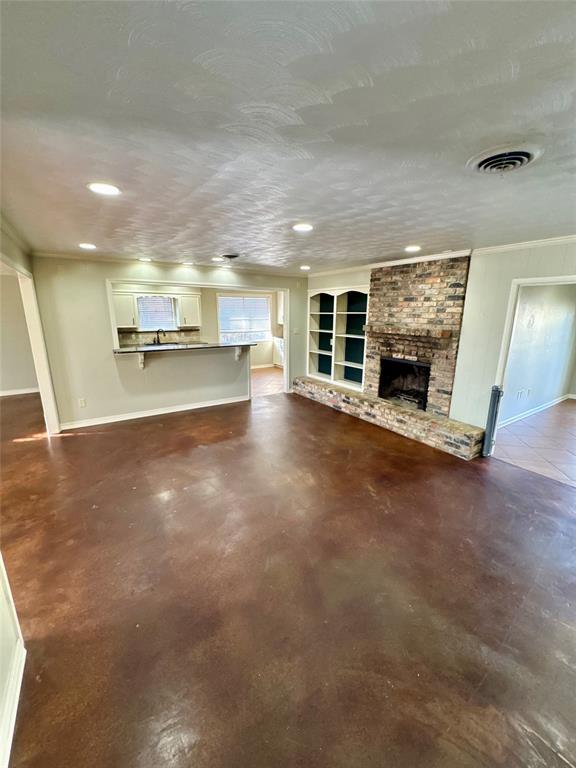 710 Robards Street Shreveport, LA 71105 - Photo 4 of 12 a view of a big room with wooden floor fire place and windows