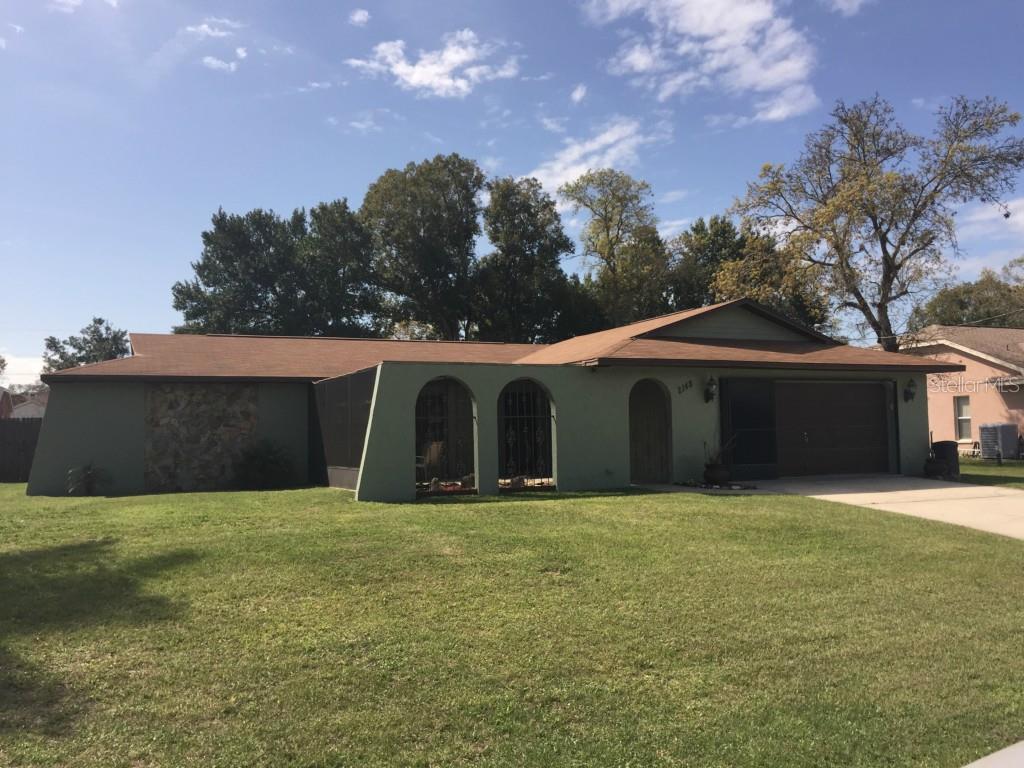2148 Bishop Road Spring Hill, FL 34608 - Photo 1 of 1 a large house with a yard