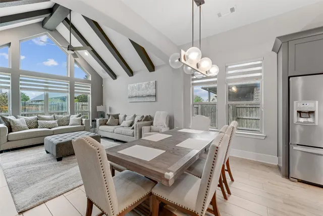 a view of a dining room with furniture large window and wooden floor