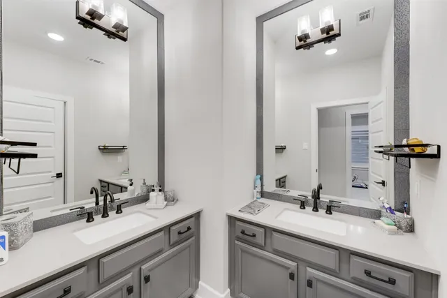 a bathroom with a sink vanity and mirror