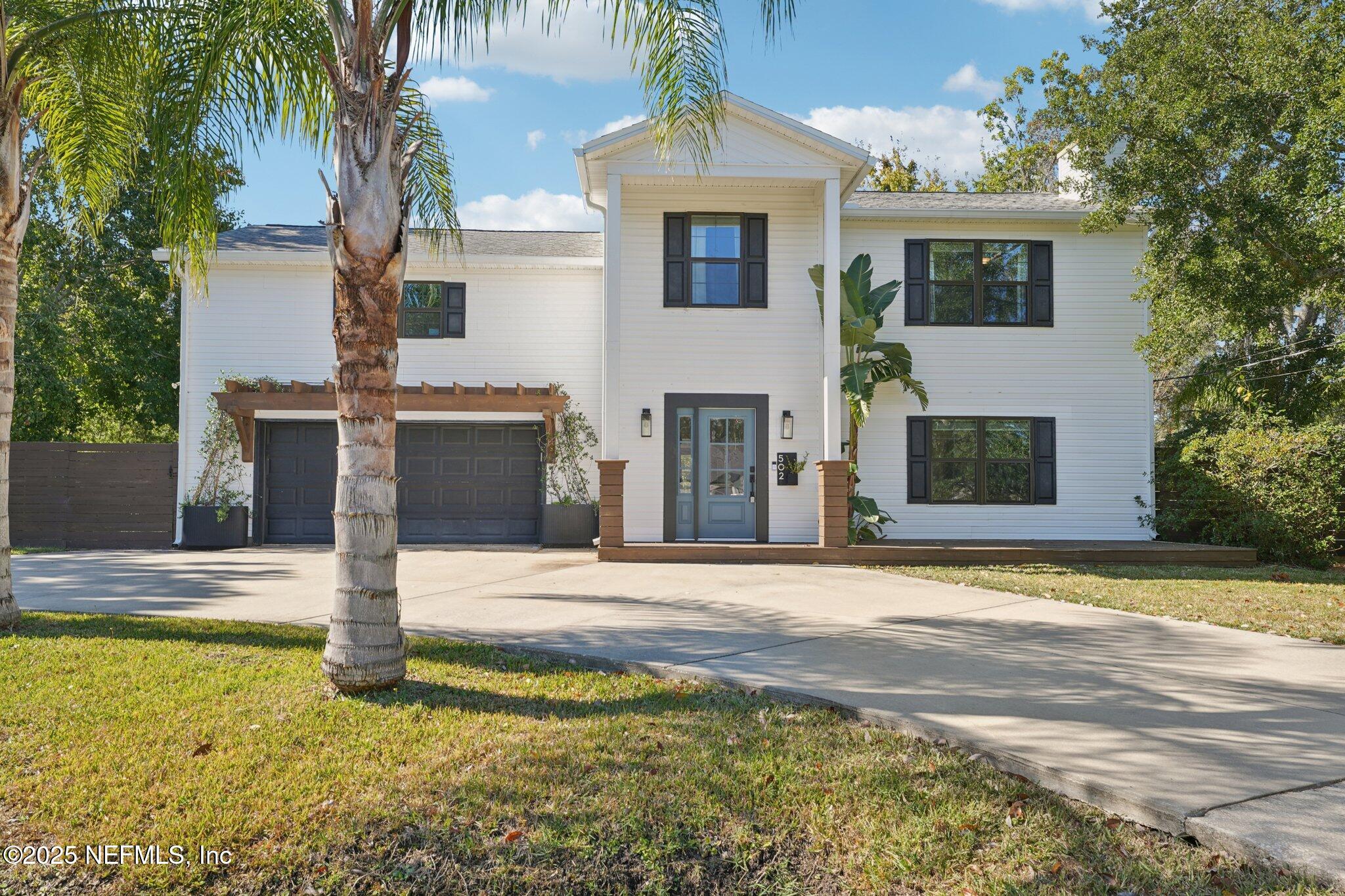 a front view of a house with a garden