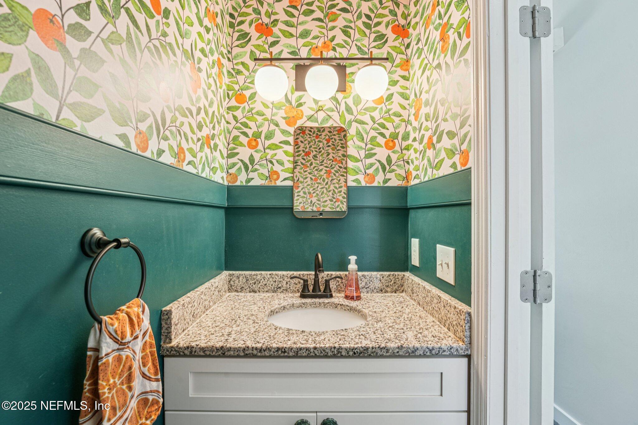 502 Royal Road St. Augustine, FL 32086 - Photo 12 of 34 a bathroom with a granite countertop sink and a mirror