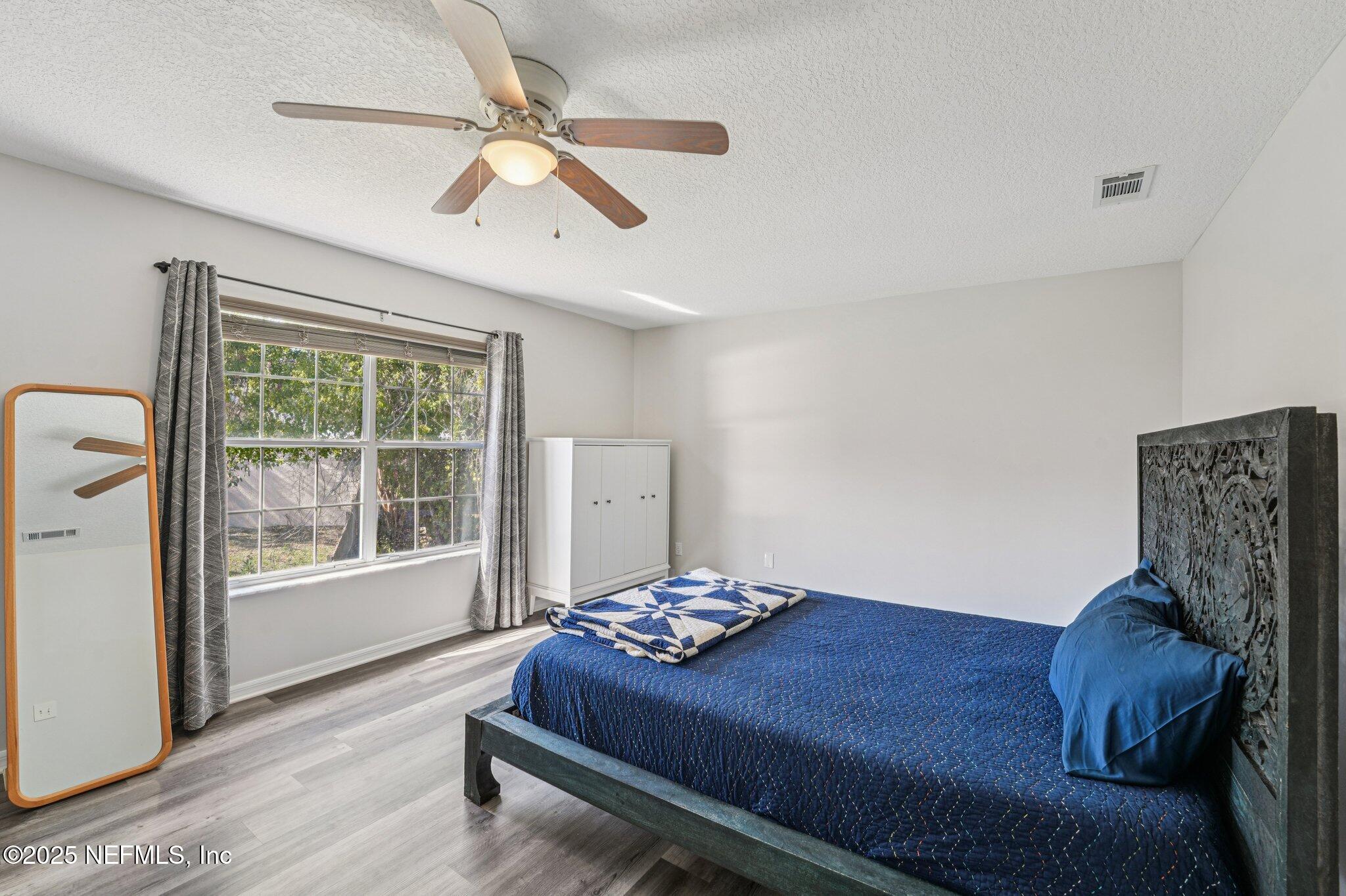 502 Royal Road St. Augustine, FL 32086 - Photo 14 of 34 a living room with a bed furniture and a large window