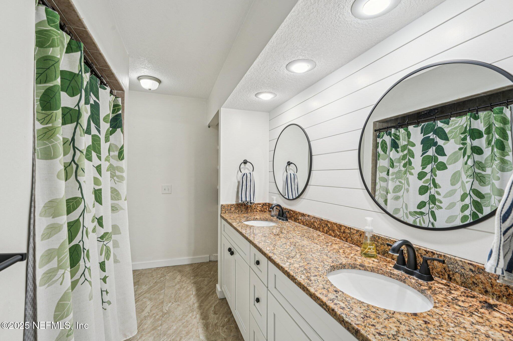 502 Royal Road St. Augustine, FL 32086 - Photo 16 of 34 a bathroom with a granite countertop sink and mirror