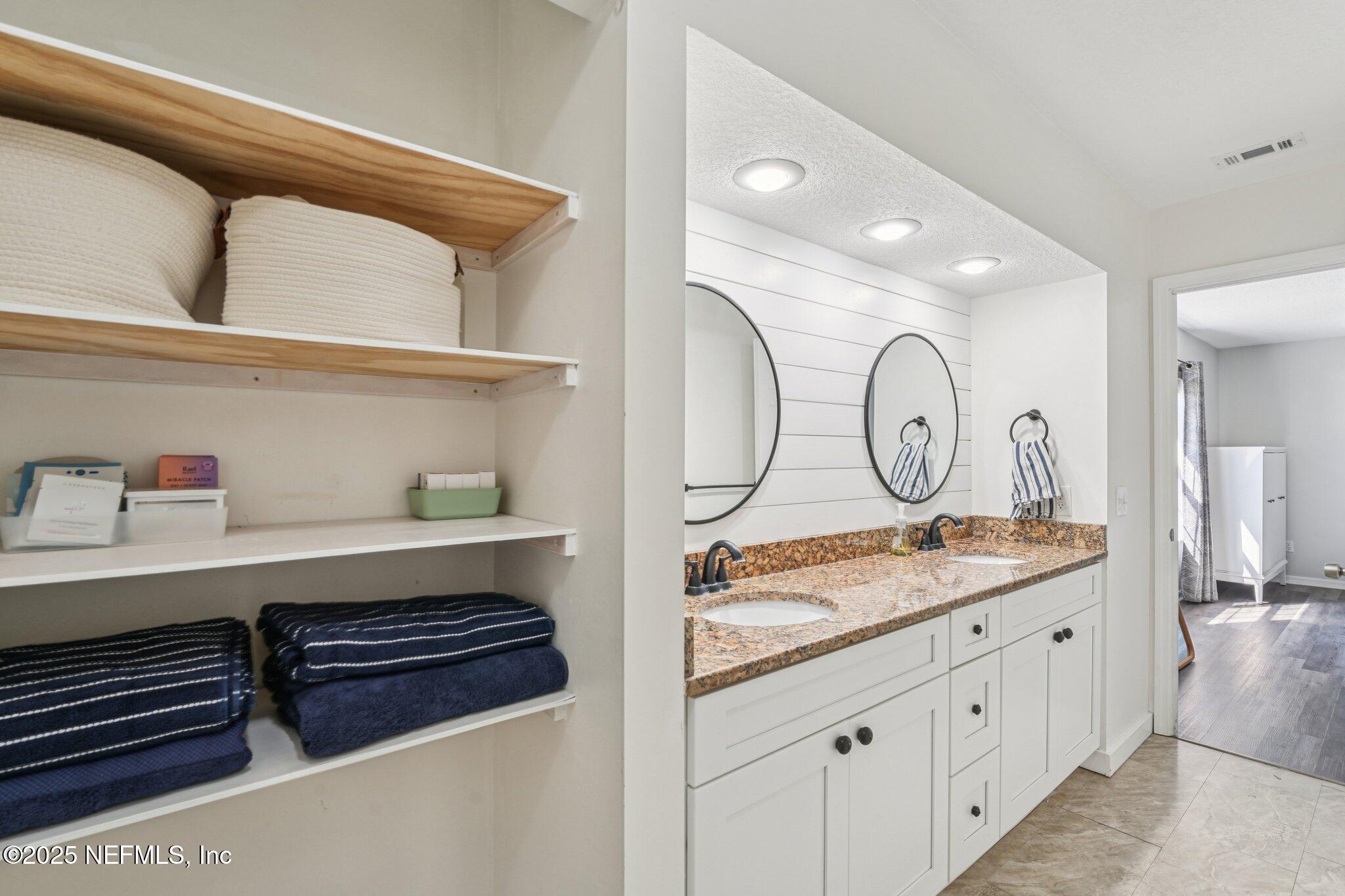 502 Royal Road St. Augustine, FL 32086 - Photo 17 of 34 a bathroom with a sink a vanity and a mirror