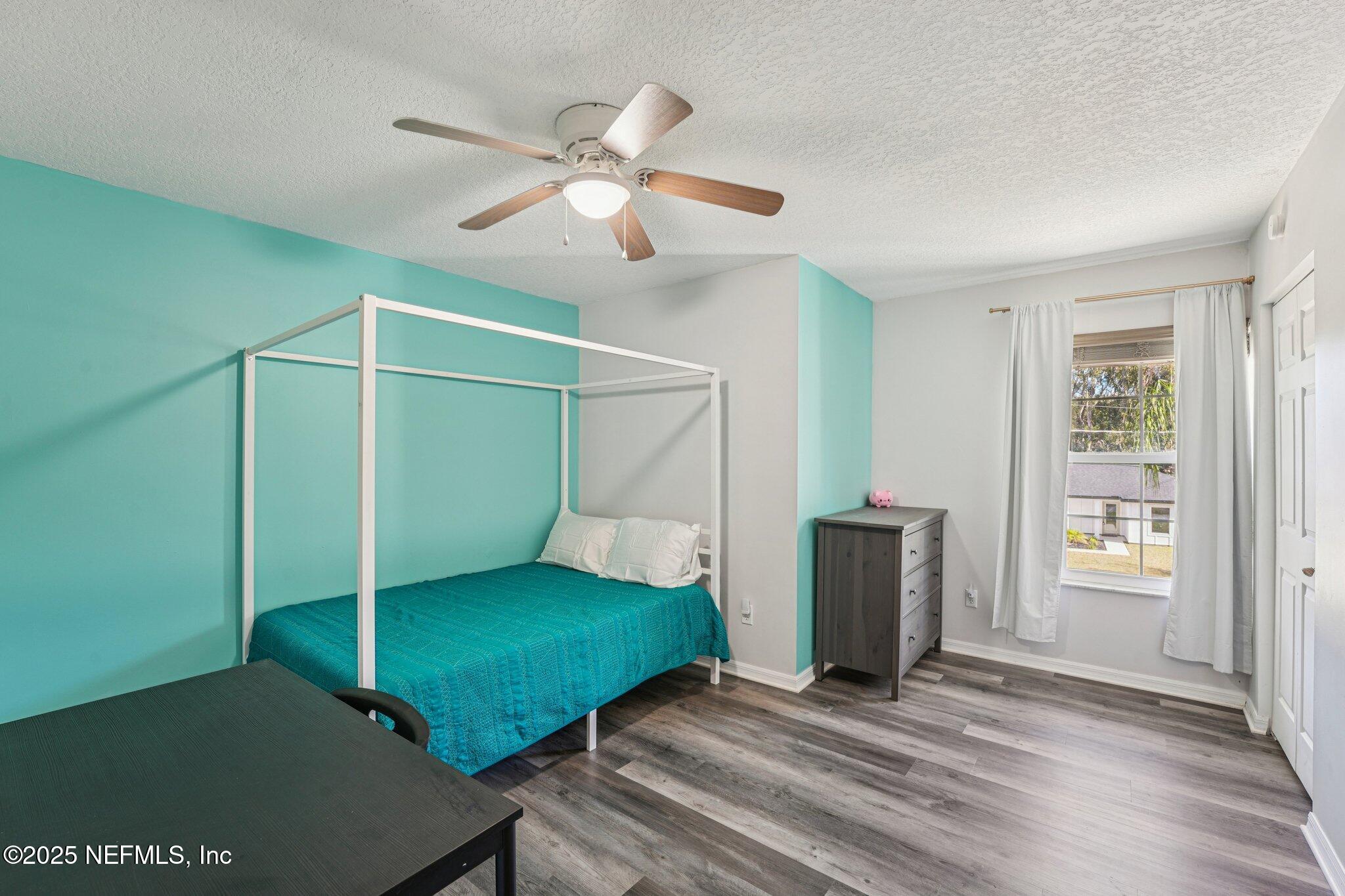 502 Royal Road St. Augustine, FL 32086 - Photo 22 of 34 a view of an empty room with window and wooden floor