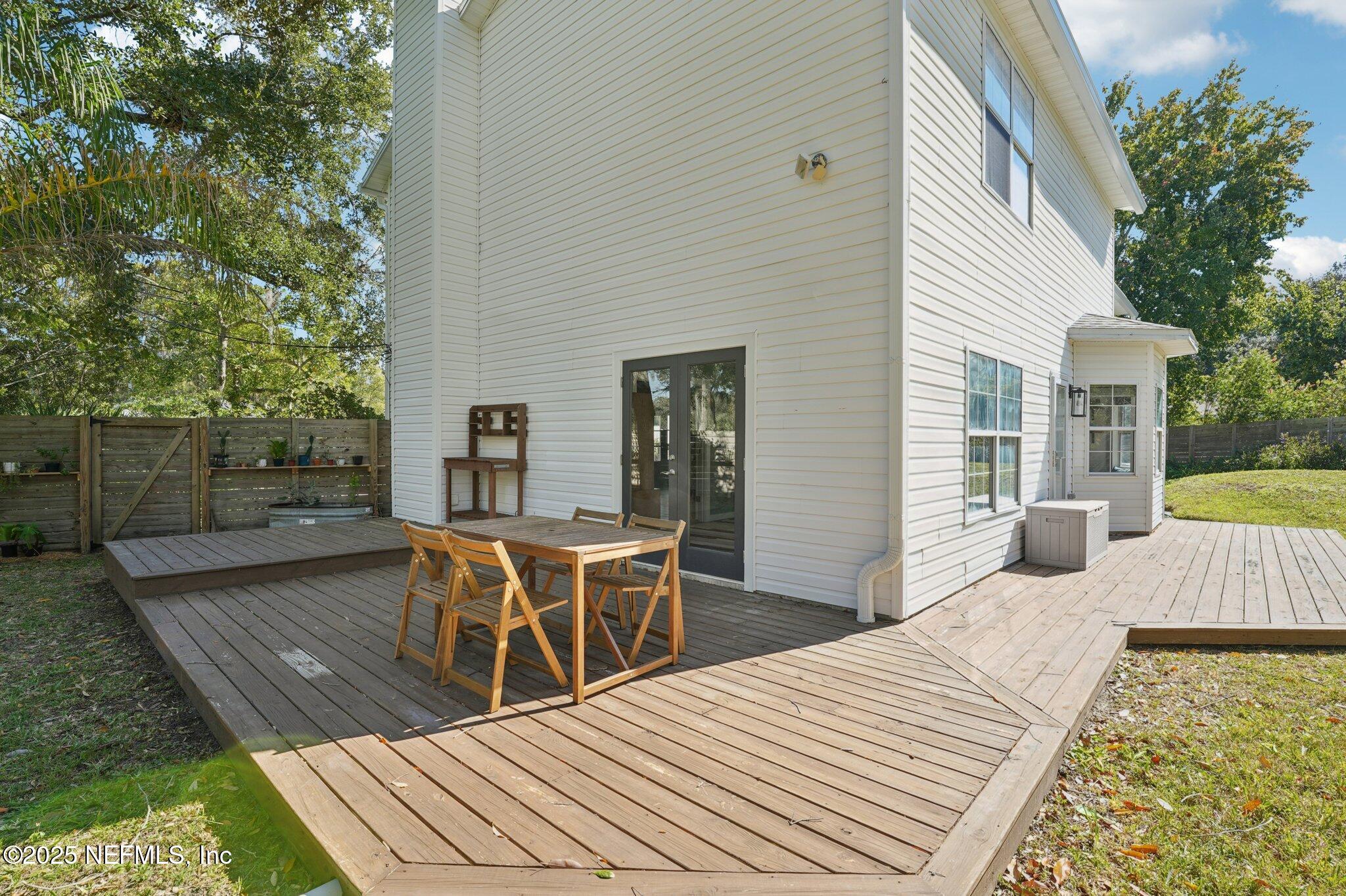 502 Royal Road St. Augustine, FL 32086 - Photo 26 of 34 a view of a patio with table and chairs with wooden floor and fence