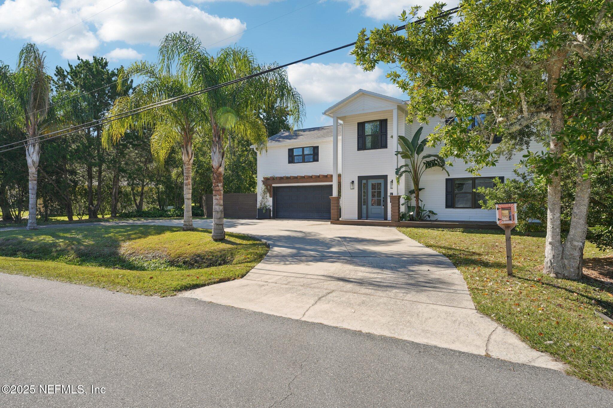 502 Royal Road St. Augustine, FL 32086 - Photo 32 of 34 a house with palm tree in front of it