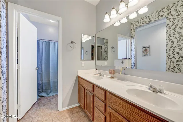 a bathroom with a double vanity sink and a mirror