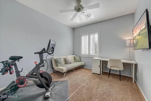 a living room with furniture a flat screen tv and a window