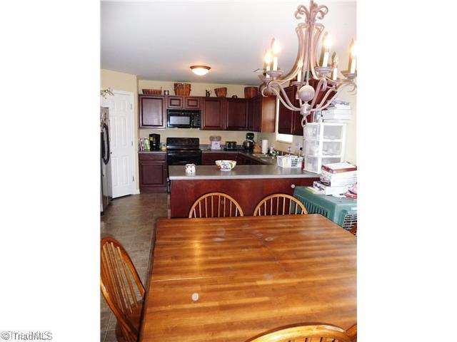 3563 Osceola Road Elon, NC 27244 - Photo 3 of 4 Kitchen. Open to the den and a door leading to the back yard patio
