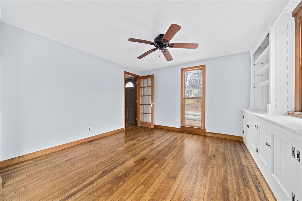 79 Pecksuot Road Weymouth, MA 02191 - Photo 12 of 42 a view of empty room with wooden floor and fan