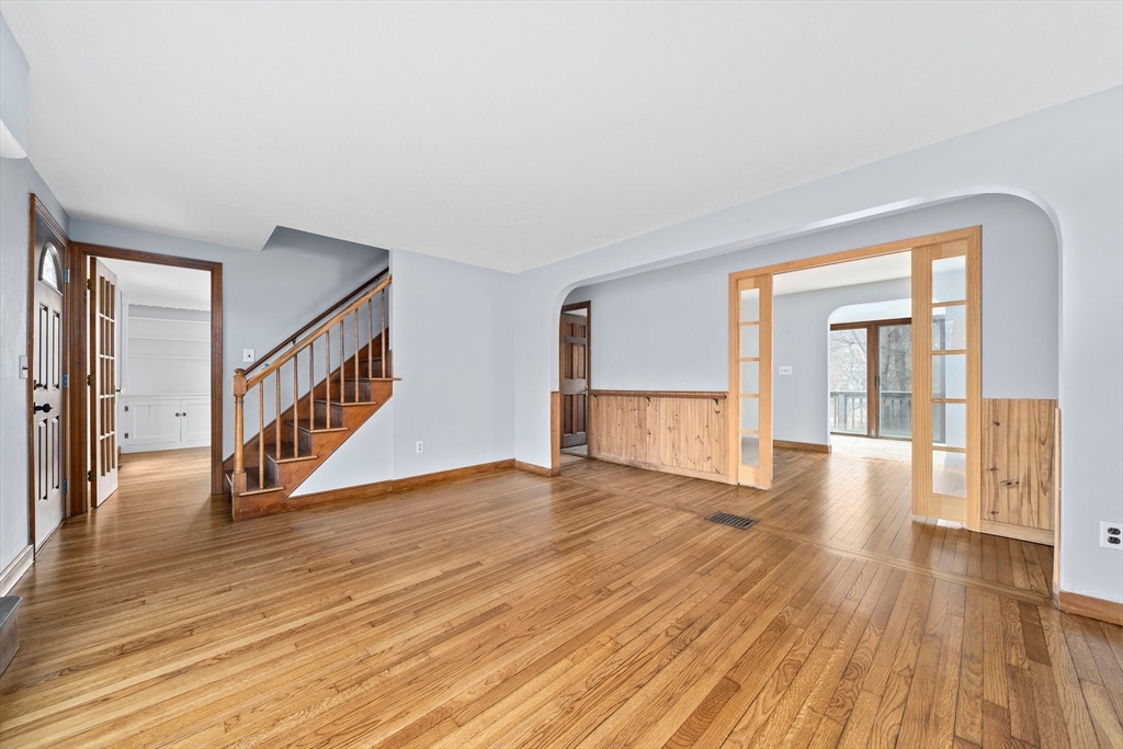 79 Pecksuot Road Weymouth, MA 02191 - Photo 4 of 42 a view of an empty room with wooden floor and a window