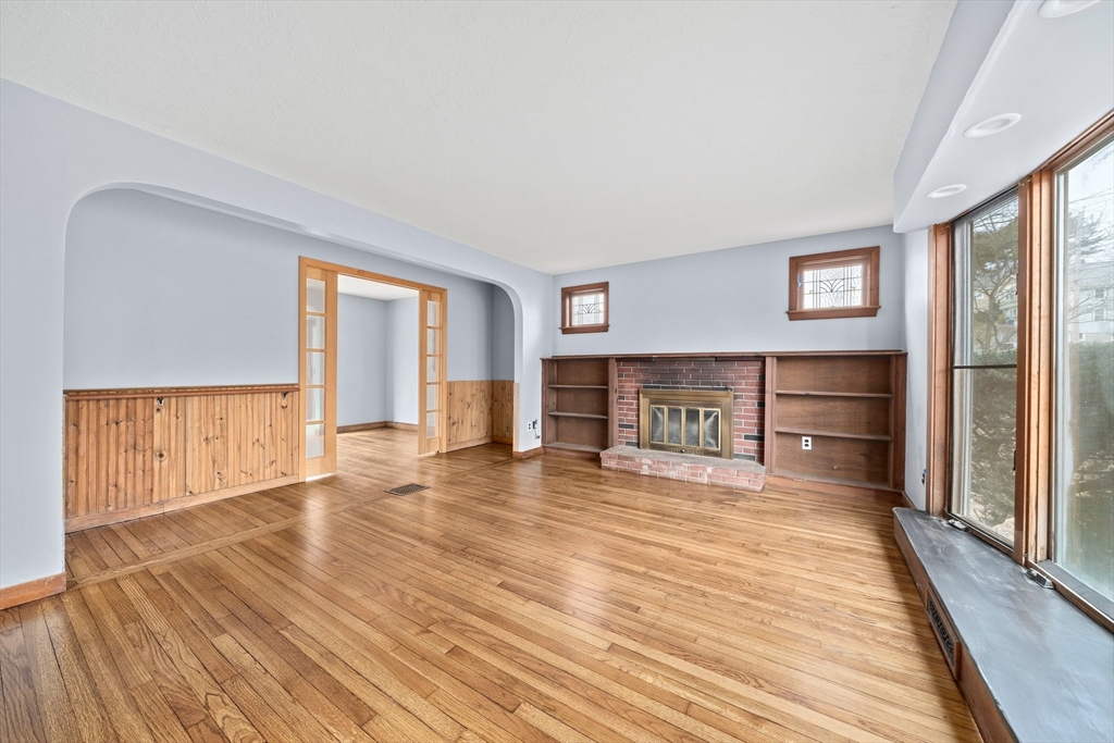 79 Pecksuot Road Weymouth, MA 02191 - Photo 5 of 42 a big room with wooden floor and windows