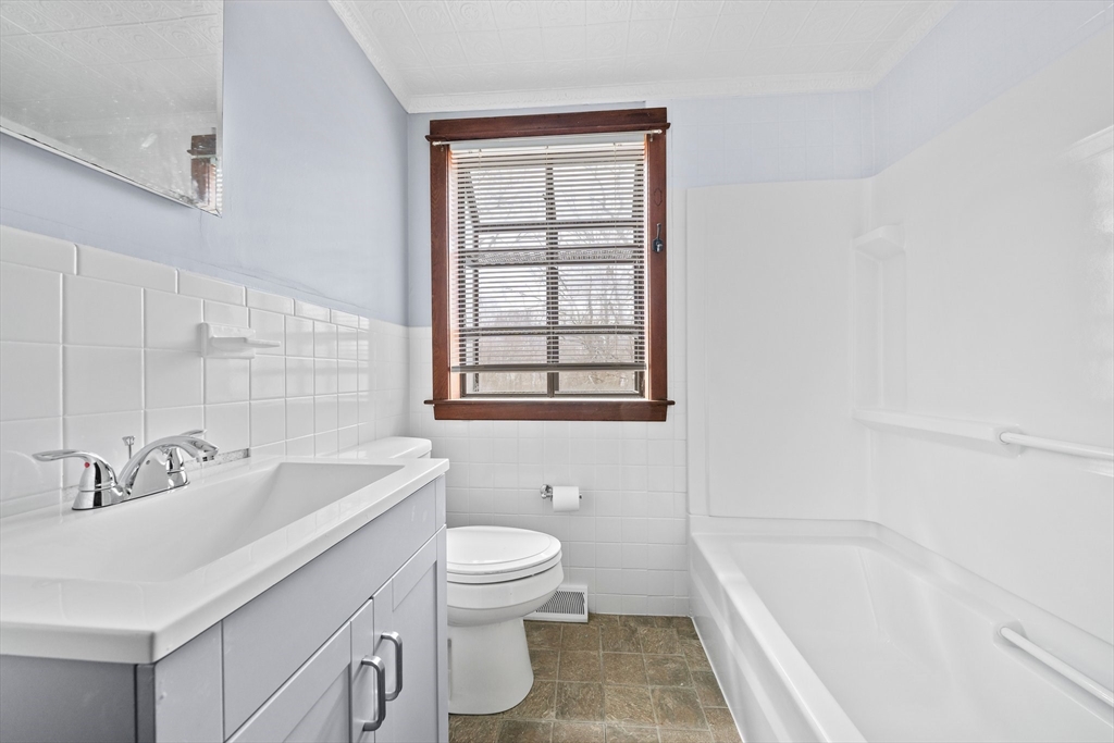 79 Pecksuot Road Weymouth, MA 02191 - Photo 10 of 42 a bathroom with a sink a toilet and bathtub