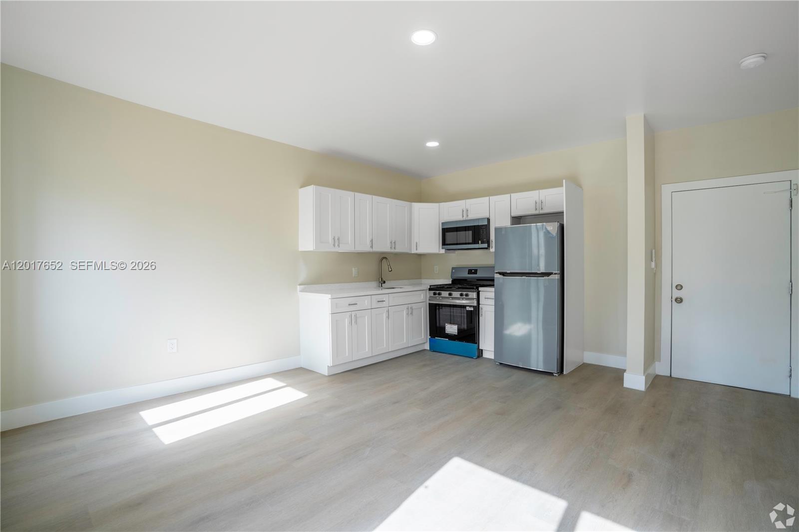 433 Southwest 6th Street, Unit 15 Miami, FL 33130 - Photo 2 of 12 a kitchen with stainless steel appliances a refrigerator and a stove top oven
