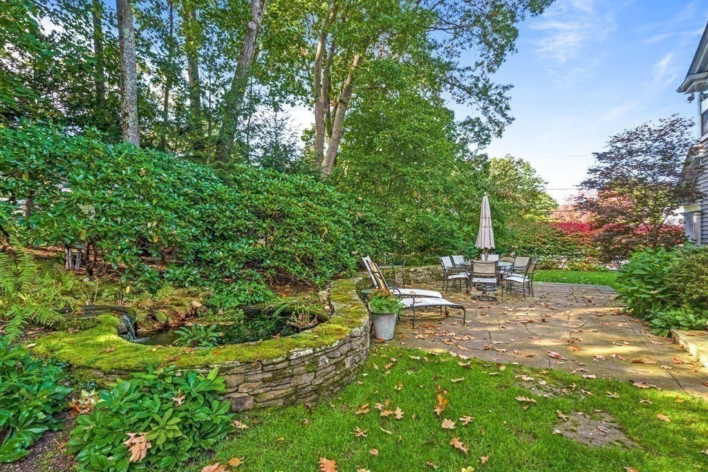 138 Hampshire Road Wellesley, MA 02481 - Photo 22 of 25 a view of a chairs and table in the garden