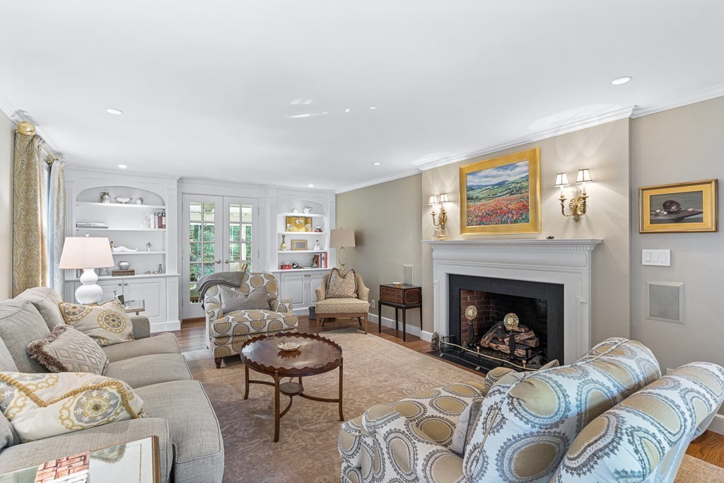 138 Hampshire Road Wellesley, MA 02481 - Photo 4 of 25 a living room with furniture a fireplace and a large mirror