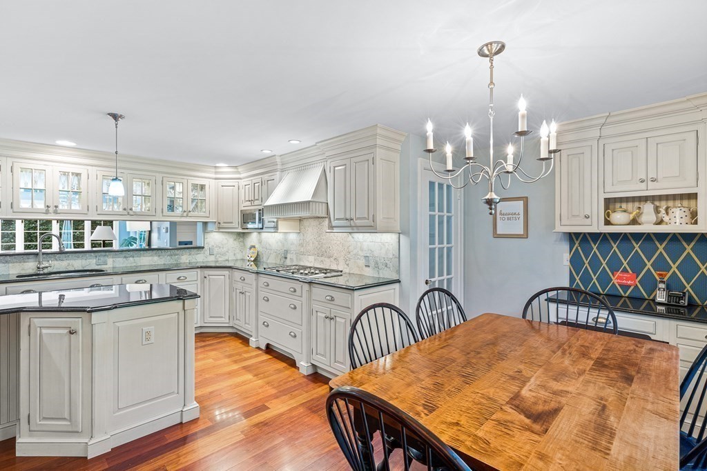 138 Hampshire Road Wellesley, MA 02481 - Photo 6 of 25 a kitchen with stainless steel appliances granite countertop a stove top oven a sink dishwasher and white cabinets with wooden floor