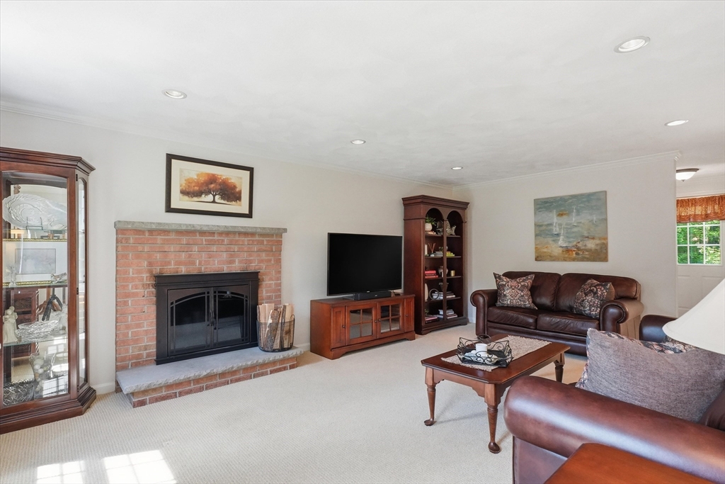 9 Fazio Farm Road Georgetown, MA 01833 - Photo 20 of 42 a living room with furniture flat screen tv and a fireplace