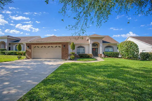 a front view of a house with a garden and yard