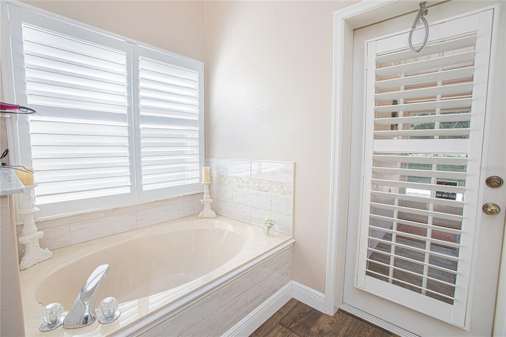 3321 Furlong Way Gotha, FL 34734 - Photo 15 of 26 a bathroom with bathtub and a window