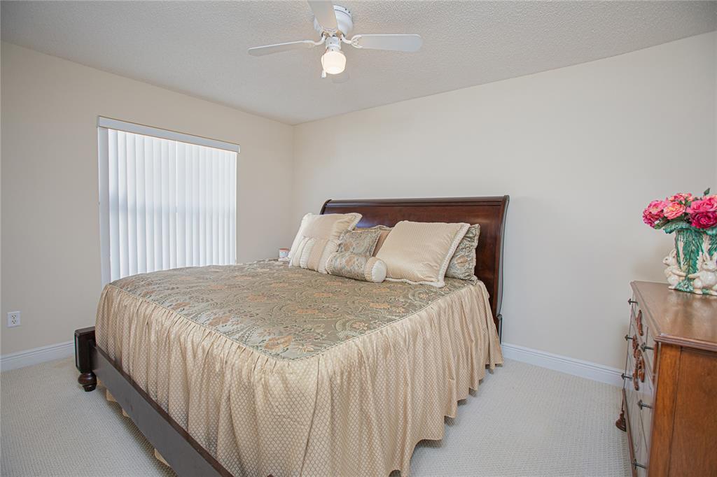 3321 Furlong Way Gotha, FL 34734 - Photo 17 of 26 a bedroom with a bed and a chandelier
