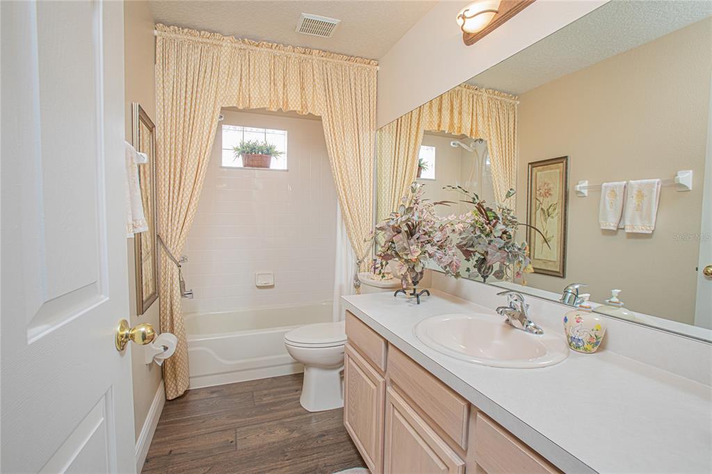 3321 Furlong Way Gotha, FL 34734 - Photo 19 of 26 a bathroom with a sink a toilet and a large mirror