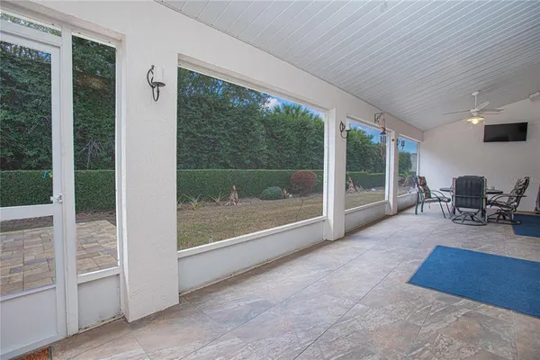 a living room with furniture and large windows