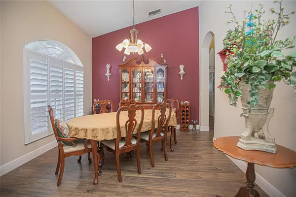 a view of a dining room with furniture and wooden floor