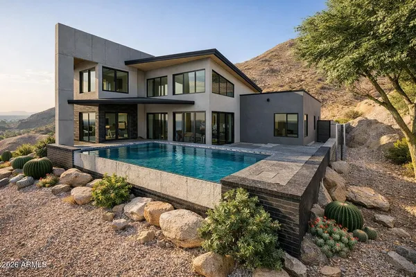 a view of a house with pool and chairs