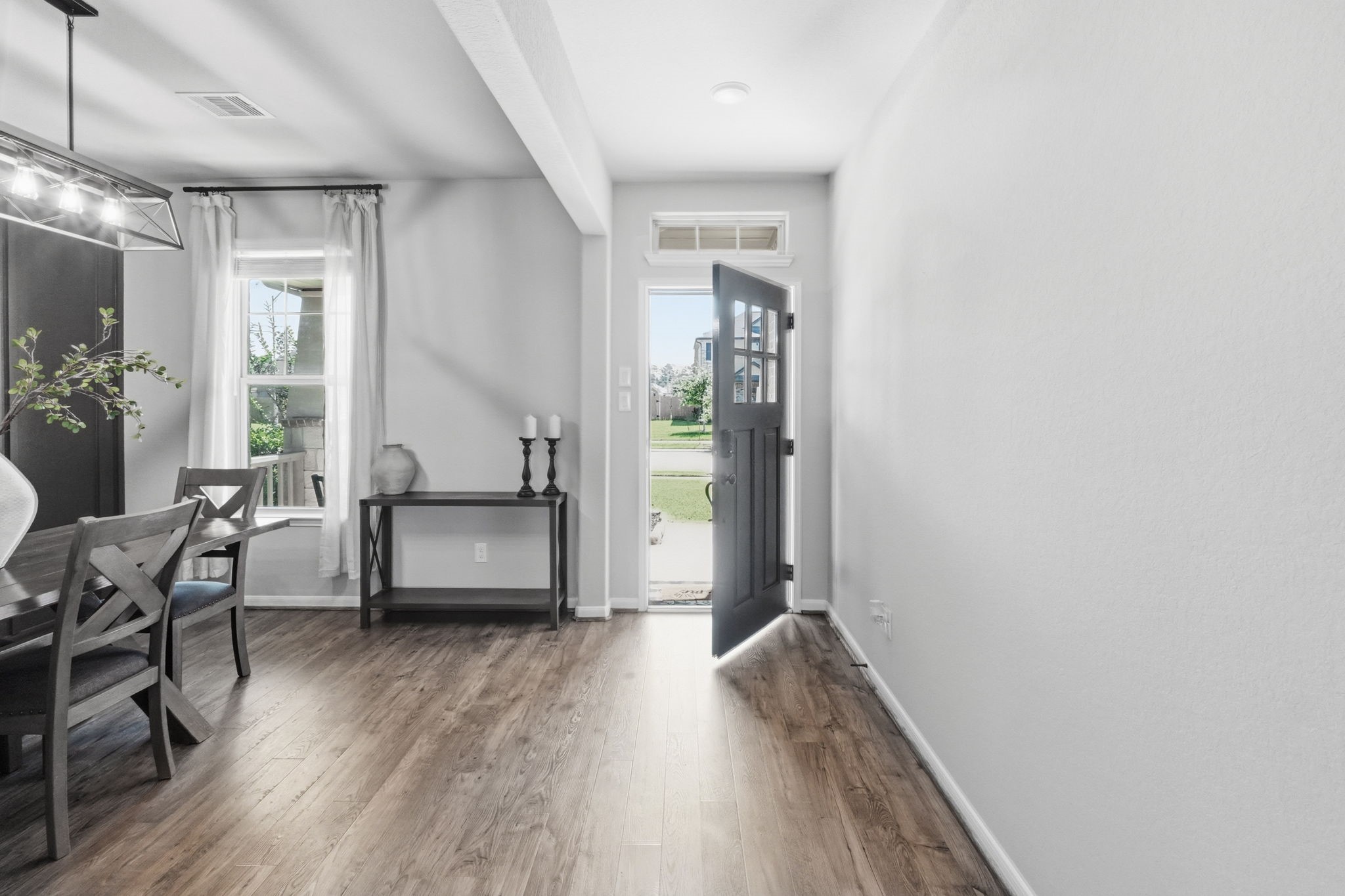 4334 Umber Shadow Drive Spring, TX 77386 - Photo 7 of 45 Dining room features wood-look flooring, natural light, and a dedicated space for entertaining or everyday gatherings.