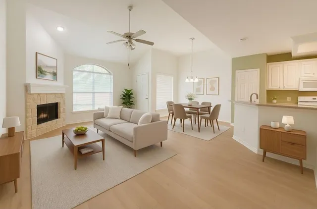 a living room with fireplace furniture and a chandelier