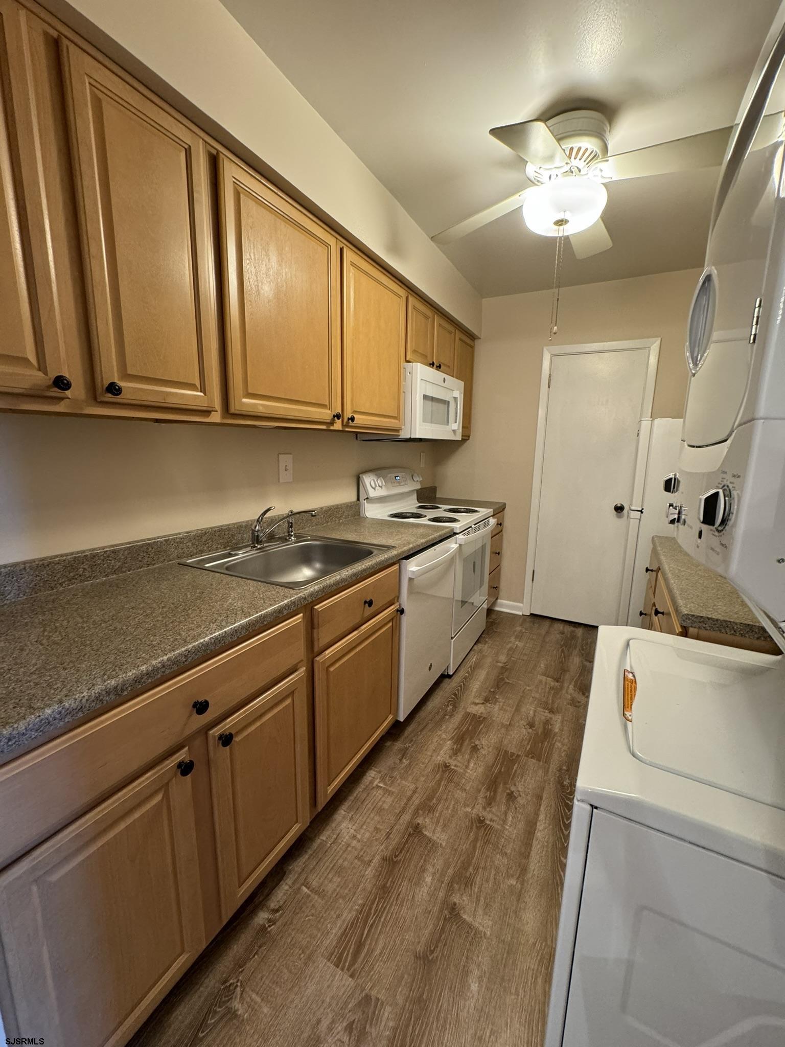 11 Shore Road, Unit 7A Somers Point, NJ 08244 - Photo 5 of 18 a kitchen with cabinets a sink and appliances