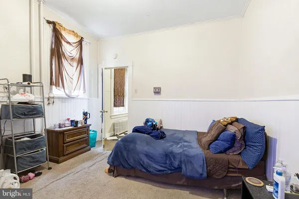 a living room with furniture and a mirror