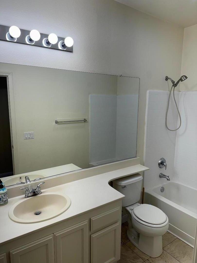 949 Terraza Street Soledad, CA 93960 - Photo 14 of 38 a bathroom with a sink toilet vanity and shower